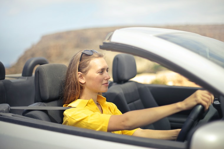 woman-in-yellow-shirt-driving-a-silver-car-787476